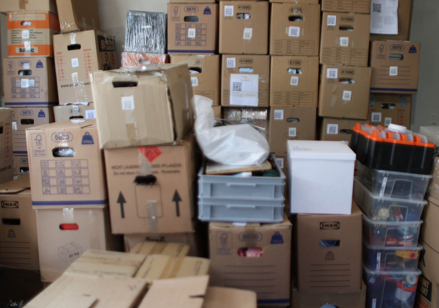 Wide basement view with shelves and stacked storage boxes